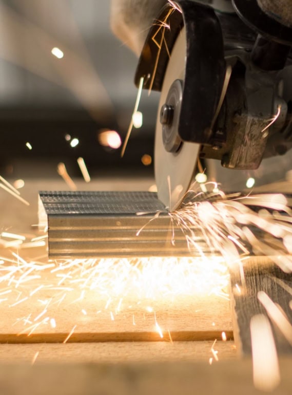 High-speed metal cutting process using a circular saw with sparks flying.