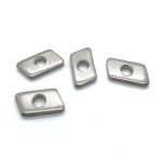 Four rhombic nuts with central holes for mechanical fastening.